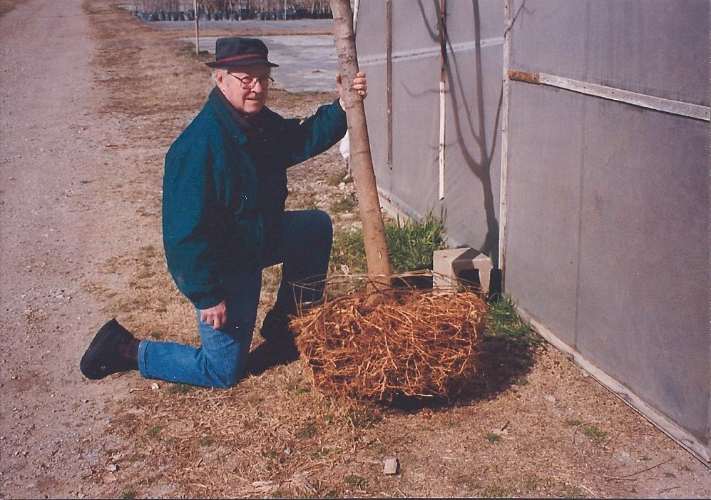 Smart Pot founder Ralph Reiger inspecting a tree root ball at his Oklahoma nursery