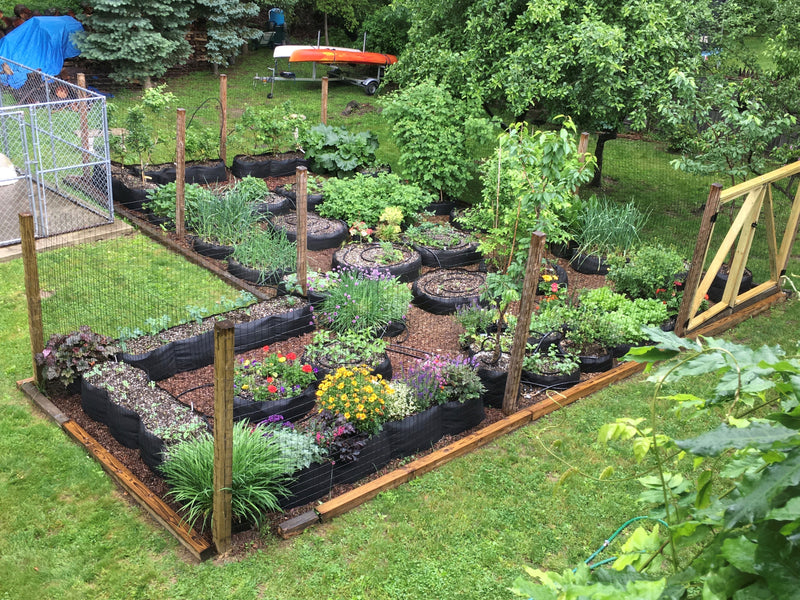 Marty’s garden with vegetables and flowers growing in Smart Pots of many sizes